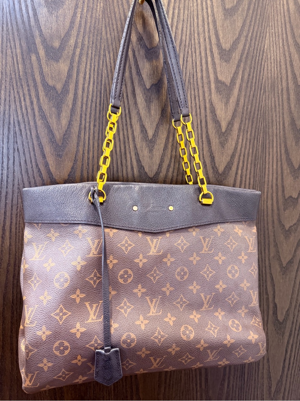 Louis Vuitton Brown and black Monogram Pallas Purse with gold hardware.